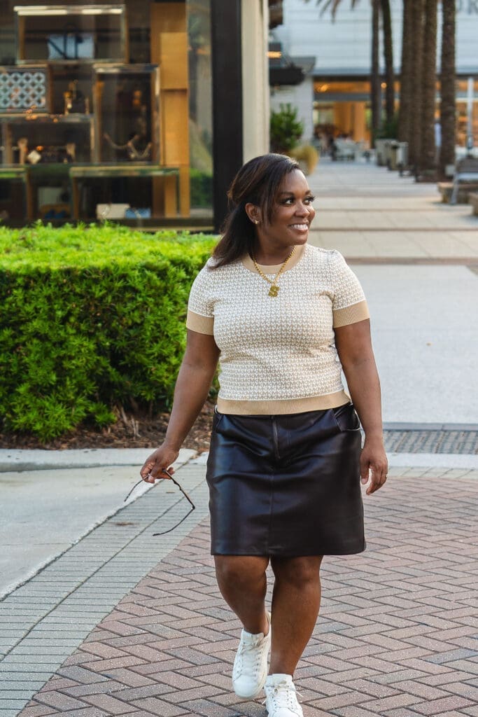 African American Women wearing McCalls 8149 faux leather brown skirt walking across the street