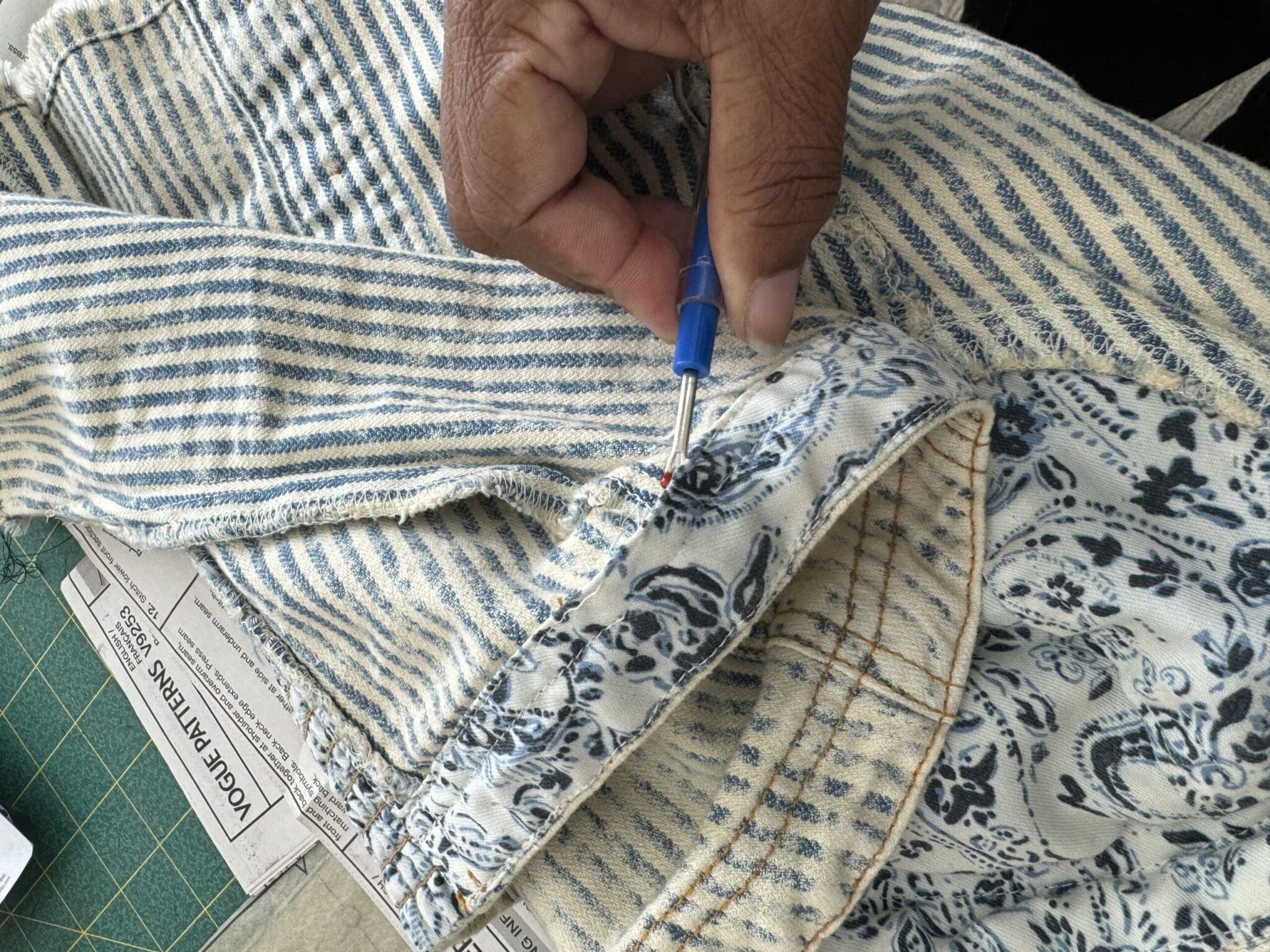 Precision seam ripper work on denim facing