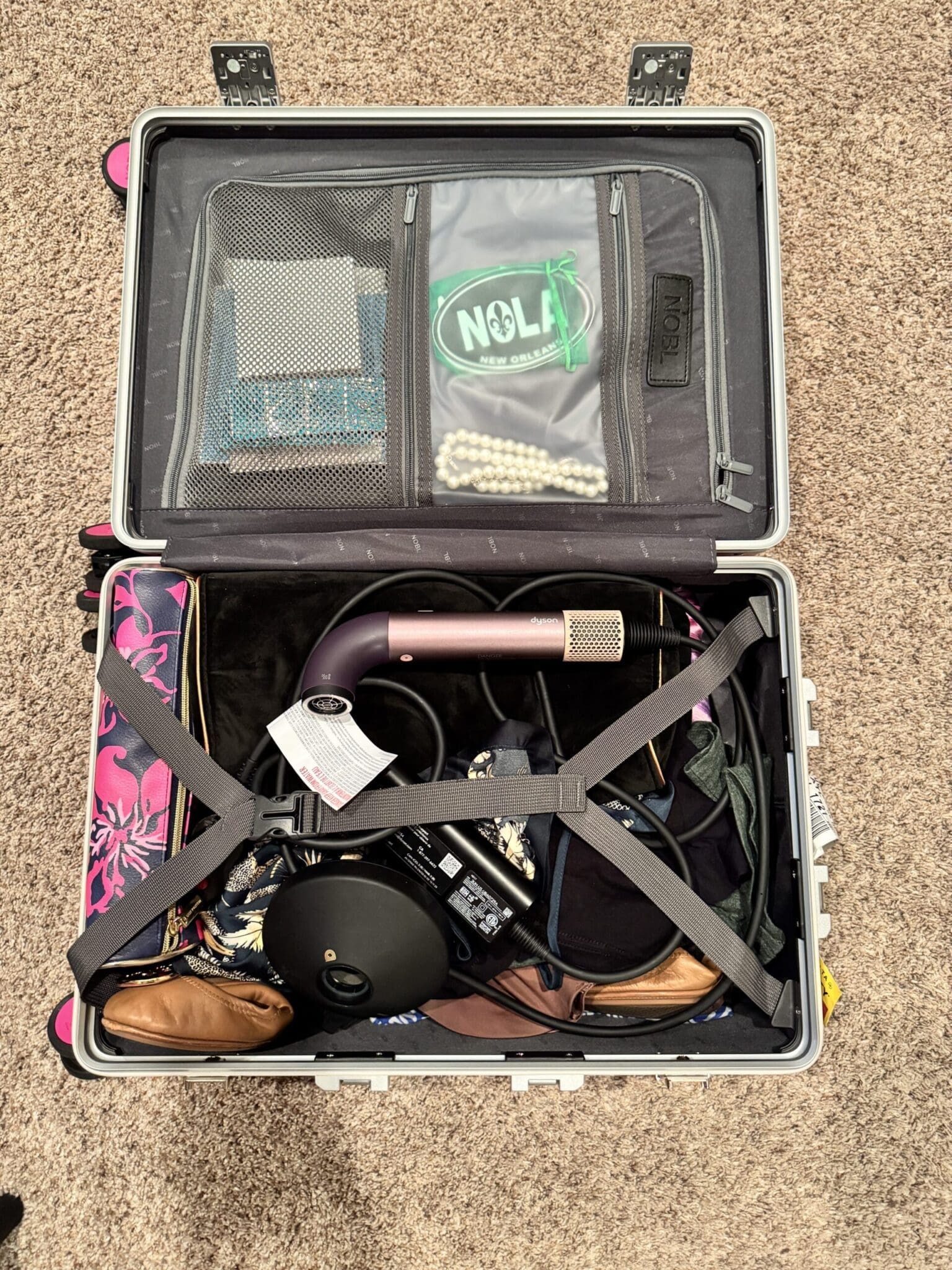 Inside the NOBL carry-on showing compression system