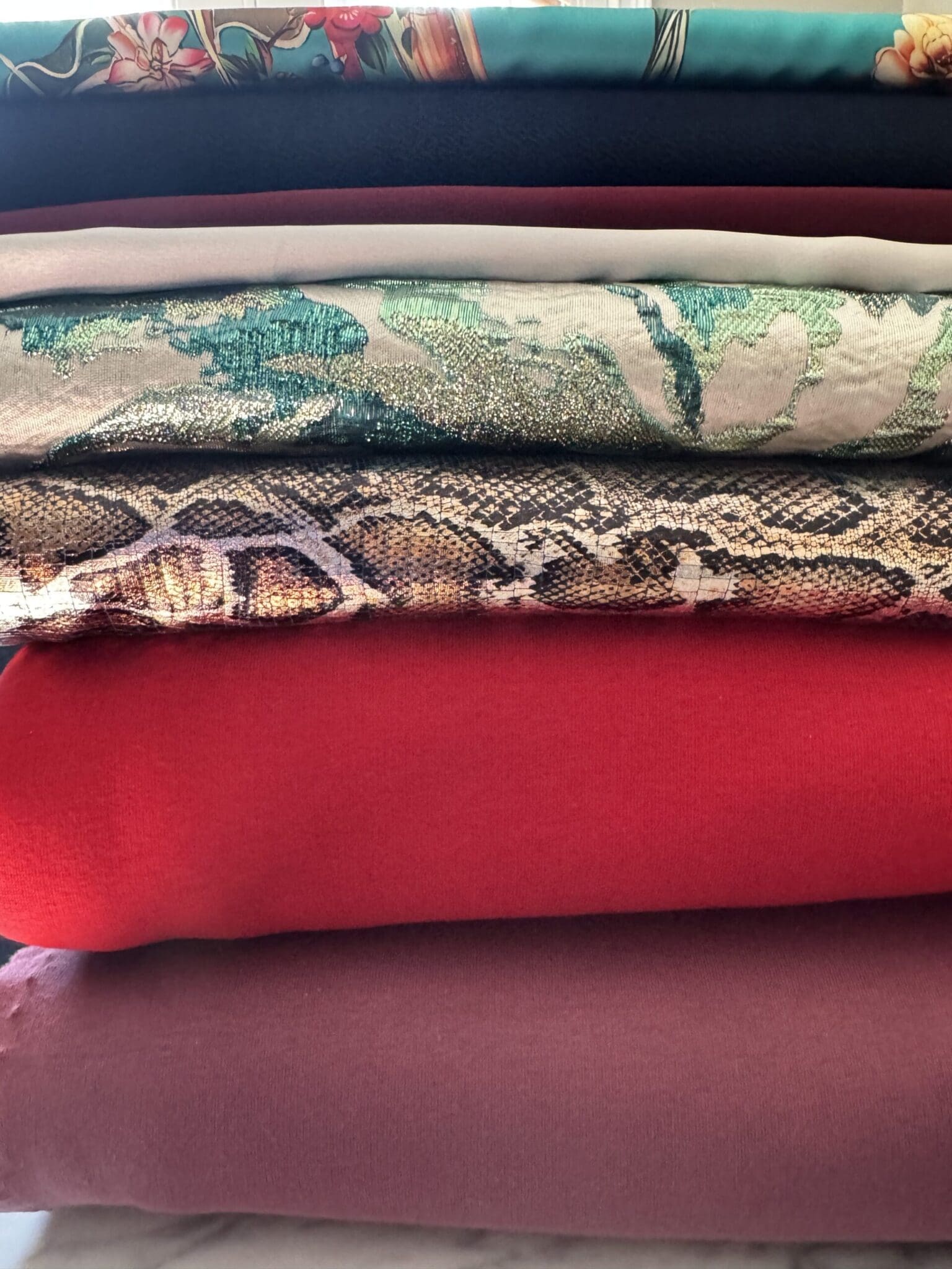 The complete 2025 curated Paris fabric haul featuring luxury silks, brocades, and textured crepes for bespoke tailoring