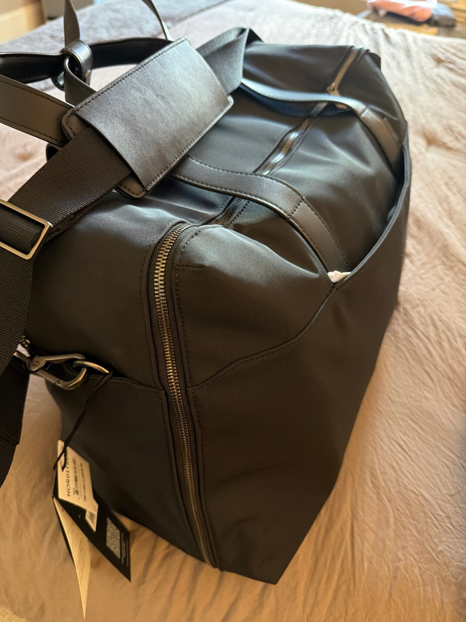 The Away Weekender bag open on a bed showing organized travel essentials
