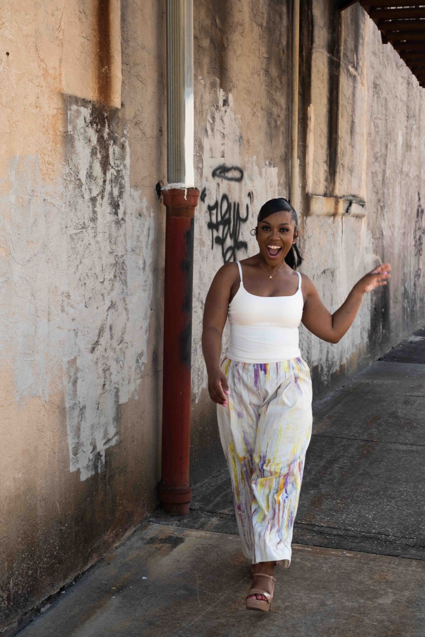 Mid-stride laughing shot of Shontae wearing custom Seamwork Marett trousers
